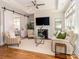 Cozy living room with a fireplace, elegant decor, and a sliding barn door leading to another living area at 2209 Lincolnshire Ln, Waxhaw, NC 28173