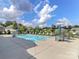 Community pool with lounge chairs and umbrella-covered tables, ideal for relaxation and socializing at 2209 Lincolnshire Ln, Waxhaw, NC 28173