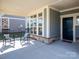 Inviting covered porch with rocking chairs, creating a cozy outdoor space near the front door and windows at 2209 Lincolnshire Ln, Waxhaw, NC 28173