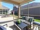 Inviting screened porch with stylish furniture, a ceiling fan, and views of the backyard at 2209 Lincolnshire Ln, Waxhaw, NC 28173