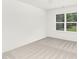 Bedroom featuring neutral carpet, white walls, base molding, and a bright window at 222 Ventner Ct, Charlotte, NC 28214