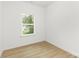 Bedroom featuring vinyl floors, white walls, base molding, and a bright window at 222 Ventner Ct, Charlotte, NC 28214