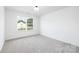Bright bedroom with plush carpeting and a large window offering ample natural light at 222 Ventner Ct, Charlotte, NC 28214