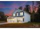 Charming two-story home featuring a covered front porch and attached two-car garage with brick accents at 222 Ventner Ct, Charlotte, NC 28214