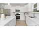 Bright kitchen featuring stainless steel appliances, white cabinets and light wood floors at 222 Ventner Ct, Charlotte, NC 28214