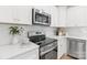 Modern kitchen with stainless steel appliances, white countertops, and sleek white cabinetry at 222 Ventner Ct, Charlotte, NC 28214
