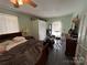 Comfortable bedroom featuring neutral decor, a ceiling fan, and closet storage at 228 Hazeleen Ave, Belmont, NC 28012