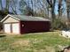 Spacious two-car garage featuring white doors and a red brick exterior, set on a grassy lawn at 228 Hazeleen Ave, Belmont, NC 28012