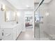 Modern bathroom showcasing a glass shower, stylish vanity, and a glimpse into the bedroom at 2401 Euclid Ave # 306, Charlotte, NC 28203
