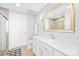 Bright bathroom featuring a modern vanity, gold framed mirror, and a glass-enclosed shower at 2401 Euclid Ave # 306, Charlotte, NC 28203