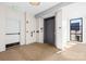 Well-lit hallway featuring an elevator, exit door, and windows, creating a welcoming entrance at 2401 Euclid Ave # 306, Charlotte, NC 28203