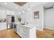 Stylish kitchen featuring a large island with quartz countertop, stainless steel appliances, and white cabinets with gold hardware at 2401 Euclid Ave # 306, Charlotte, NC 28203