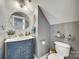Cozy bathroom with a blue vanity, gold accents and a shiplap wall at 249 Sand Paver Way, Fort Mill, SC 29708
