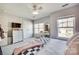 Bright bedroom features a ceiling fan, a vanity, and a window providing lots of natural light at 249 Sand Paver Way, Fort Mill, SC 29708