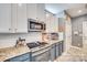Charming kitchen features white cabinets, stainless steel appliances, and granite countertops at 249 Sand Paver Way, Fort Mill, SC 29708