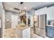 Well-lit kitchen with a stainless steel refrigerator and a granite countertop center island at 249 Sand Paver Way, Fort Mill, SC 29708