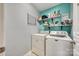Practical laundry room equipped with washer, dryer, shelving, and stylish wall color at 249 Sand Paver Way, Fort Mill, SC 29708