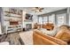 Inviting living room featuring hardwood floors, a fireplace, and comfortable leather furniture at 249 Sand Paver Way, Fort Mill, SC 29708