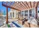 Outdoor patio area with an umbrella table, wicker seating, and a beautiful pergola at 249 Sand Paver Way, Fort Mill, SC 29708