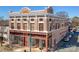 The renovated Kress building featuring retail spaces, with large windows and a red trim facade at 300 S Main St # K, Salisbury, NC 28144