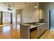 Open concept kitchen with stainless steel appliances and hardwood floors at 300 S Main St # K, Salisbury, NC 28144