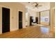 Bright living room with hardwood floors, black accent doors, and a ceiling fan at 300 S Main St # K, Salisbury, NC 28144