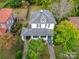 Aerial view of a well-maintained two-story home surrounded by lush greenery and trees at 306 W Marsh St, Salisbury, NC 28144