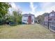 A spacious backyard shows the house with a brick chimney and a wooden fence at 306 W Marsh St, Salisbury, NC 28144