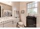 Bright bathroom with black and white tile, a large mirror, and classic fixtures at 306 W Marsh St, Salisbury, NC 28144