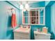 Aqua bathroom featuring bright decor, single sink vanity, and classic white toilet at 306 W Marsh St, Salisbury, NC 28144