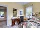 Bedroom featuring a wooden desk, a window, and a quaint, comfortable bed at 306 W Marsh St, Salisbury, NC 28144