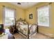 Sunlit bedroom with a cozy iron bed frame and windows that bring in natural light at 306 W Marsh St, Salisbury, NC 28144