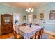 Cozy dining room with a large table, classic furnishings, and hardwood flooring at 306 W Marsh St, Salisbury, NC 28144