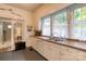 Classic kitchen featuring white cabinets, a stainless steel sink, and natural light at 306 W Marsh St, Salisbury, NC 28144