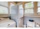 Washer and dryer set in a bright laundry room with storage and natural light at 306 W Marsh St, Salisbury, NC 28144