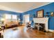 Spacious living room with hardwood floors, fireplace, and large windows at 306 W Marsh St, Salisbury, NC 28144