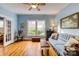 Charming living room with hardwood floors, blue walls, lots of windows, and a comfortable sofa at 306 W Marsh St, Salisbury, NC 28144