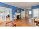Bright living room featuring a fireplace, hardwood floors, and glass panel doors at 306 W Marsh St, Salisbury, NC 28144