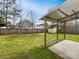 Spacious backyard with a covered patio, a wooden fence, a grassy area, and a shed at 313 Pelling Dr, York, SC 29745