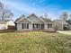 Charming single-story home featuring gray siding, black shutters, and a well-manicured lawn at 313 Pelling Dr, York, SC 29745