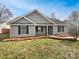 Home exterior with gray siding, black shutters, and a well-manicured front yard at 313 Pelling Dr, York, SC 29745