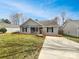 Charming single-story home with a well-maintained front lawn and a paved driveway at 313 Pelling Dr, York, SC 29745