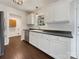 Modern kitchen with stainless steel appliances, white cabinets, and hardwood floors at 313 Pelling Dr, York, SC 29745