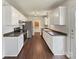Modern kitchen with stainless steel appliances, white cabinets, dark counters, and open floor plan at 313 Pelling Dr, York, SC 29745