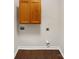 Bright laundry area with convenient hookups, hardwood floors, and a storage cabinet at 313 Pelling Dr, York, SC 29745