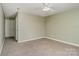 Cozy bedroom featuring neutral paint, plush carpet, a ceiling fan, and ample natural light at 3230 Richway Ct, Charlotte, NC 28216