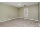 Comfortable bedroom with neutral walls, carpet flooring, a window offering natural light and a ceiling fan at 3230 Richway Ct, Charlotte, NC 28216