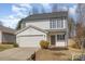 Charming two-story home with a well-maintained lawn, attached garage, and inviting front porch at 3230 Richway Ct, Charlotte, NC 28216