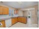 Charming kitchen features light oak cabinets, granite countertops, white appliances, and a view to the backyard at 3230 Richway Ct, Charlotte, NC 28216