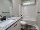Bathroom featuring a single sink vanity with granite countertop and a bathtub with shower at 404 Imperial Way, Albemarle, NC 28001